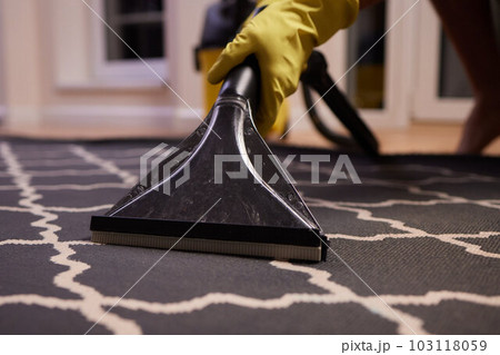 Close-up Of A Person Cleaning Carpet With Vacuum Cleaner. 103118059