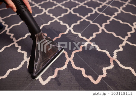 Close-up Of A Person Cleaning Carpet With Vacuum Cleaner. Close-up Of A Person Cleaning Carpet With Vacuum Cleaner. 103118113