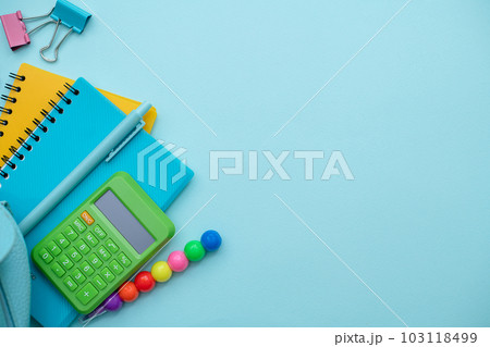 Collection different bright school stationery and notebooks on blue background, flat lay. Back to school concept Collection different bright school stationery and notebooks on blue background, flat lay. Back to school concept 103118499