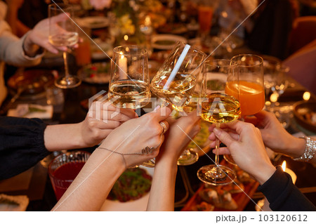 Clinking glasses with alcohol and toasting, party. 103120612