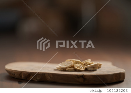 freeze dried banana chips on olive board 103122208