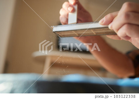 Cleaning the filter of the vacuum robot cleaner from dirt, close-up. 103122338