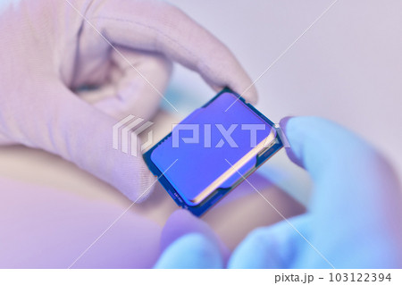 Hand in white glove holding a CPU computer processor microchip. Hand in white glove holding a CPU computer processor microchip. 103122394