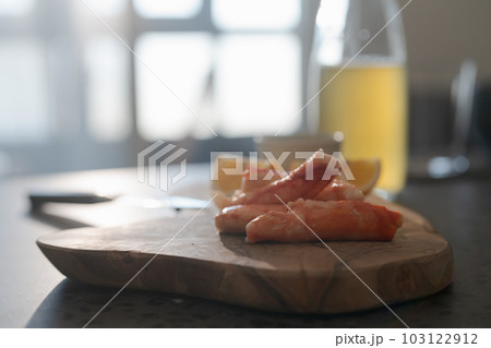 Crab legs with lemon and dressing on olive woob board Crab legs with lemon and dressing on olive woob board 103122912