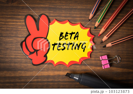Beta Testing. Sticky note with text on wood texture background 103123873