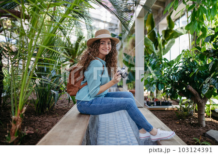Portrait of young woman in botanical garden. Portrait of young woman in botanical garden. 103124391