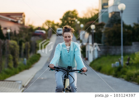 Young woman on electro bicycle, concept of commuting and ecologic traveling. 103124397
