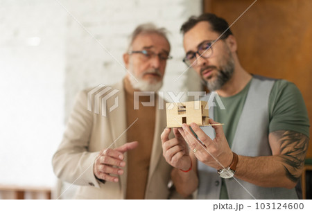 Young architects designing house for seniors client. Young architects designing house for seniors client. 103124600