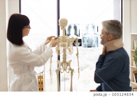 Focus on x-rays in office with doctor consulting patient 103124834