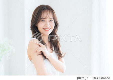 リビングでスキンケアをする若い女性 リビングでスキンケアをする若い女性 103130828