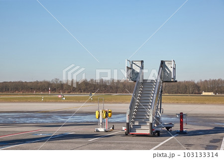 Airplane ground handling stairs standing unused, empty Airplane ground handling stairs standing unused, empty 103133314