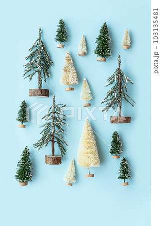 Artificial little Christmas trees layout. Winter holiday background. 103135481