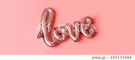 Love made from foil balloons on pink. Monochrome image. Love made from foil balloons on pink. Monochrome image. 103135484