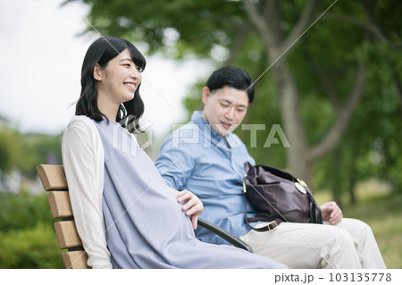 公園で休憩する妊婦と夫 公園で休憩する妊婦と夫 103135778