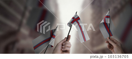 A group of people holding small flags of the Faroe Islands in their hands 103136705