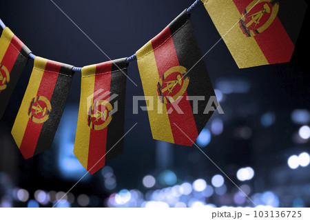 A garland of GDR national flags on an abstract blurred background 103136725