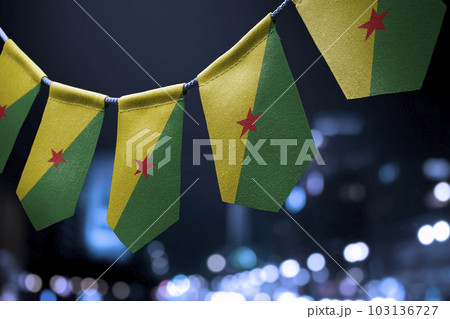 A garland of French Guiana national flags on an abstract blurred background 103136727