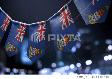 A garland of Cayman Islands national flags on an abstract blurred background 103136736