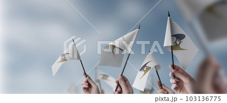 A group of people holding small flags of the Eurasian Economic Union in their hands A group of people holding small flags of the Eurasian Economic Union in their hands 103136775