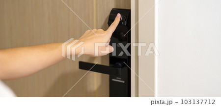Hand using fingerprint scan for smart digital door lock while open or close the door at home or apartment. NFC Technology, keycard, PIN number, smartphone and contactless lifestyle concepts Hand using fingerprint scan for smart digital door lock while open or close the door at home or apartment. NFC Technology, keycard, PIN number, smartphone and contactless lifestyle concepts 103137712