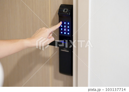 Hand press PIN number for smart digital door lock while open or close the door at home or apartment. NFC Technology, Fingerprint scan, keycard, smartphone and contactless lifestyle concepts Hand press PIN number for smart digital door lock while open or close the door at home or apartment. NFC Technology, Fingerprint scan, keycard, smartphone and contactless lifestyle concepts 103137714