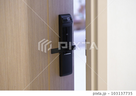 smart digital door lock while open or close the door at home or apartment. NFC Technology, Fingerprint scan, keycard, PIN number, smartphone, electrical and contactless lifestyle concepts 103137735