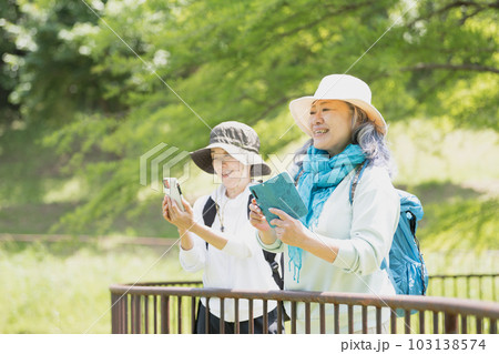 スマホのカメラで写真撮影を楽しむシニア女性友達 103138574