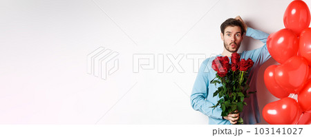 Valentines day romance. Worried boyfriend holding bouquet of red roses and red heart balloons, scratching head and looking anxious, going on romantic date, white background Valentines day romance. Worried boyfriend holding bouquet of red roses and red heart balloons, scratching head and looking anxious, going on romantic date, white background 103141027