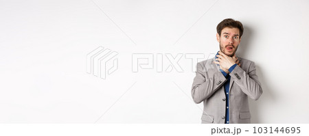 Distressed young man in business suit strangle himself and showing tongue, feeling sick with sore throat, standing on white background Distressed young man in business suit strangle himself and showing tongue, feeling sick with sore throat, standing on white background 103144695