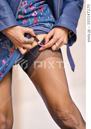 Closeup view of a woman fixing garter belt 103147270