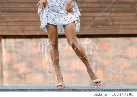 Beautiful female legs dancing outdoor, stretch leg to the side Beautiful female legs dancing outdoor, stretch leg to the side 103147296