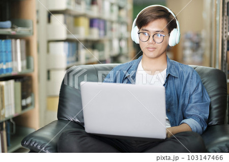 Student online studying at library. Student online studying at library. 103147466