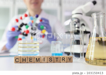 Word Chemistry against lab assistant showing molecule model 103150413