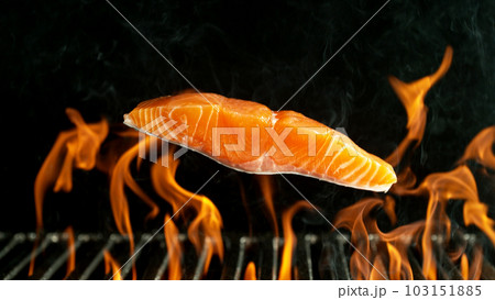 Barbecue Grill With Falling Raw Salmon Steak. Barbecue Grill With Falling Raw Salmon Steak. 103151885