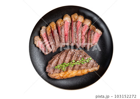 Sliced grilled medium rare Top sirloin beef steak on a plate. Isolated on white background. Sliced grilled medium rare Top sirloin beef steak on a plate. Isolated on white background. 103152272