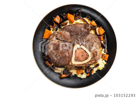 Osso buco cross cut veal shank with mashed potato on a plate. Isolated on white background. Osso buco cross cut veal shank with mashed potato on a plate. Isolated on white background. 103152293