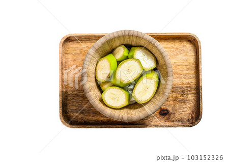 Sliced green banana in a wooden bowl. Isolated on white background. Sliced green banana in a wooden bowl. Isolated on white background. 103152326