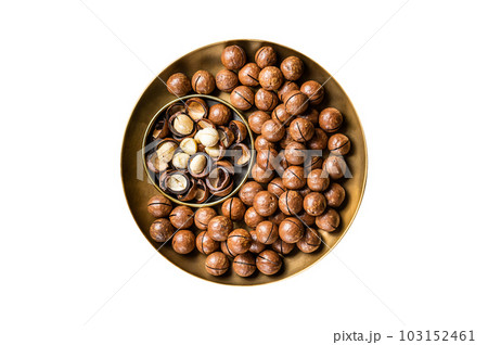 Organic Macadamia nuts in a shell ready to eat. Isolated on white background. 103152461