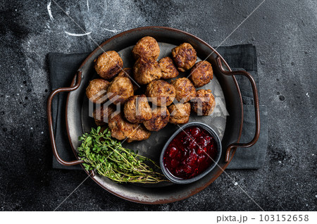 Homemade Swedish meatballs with lingonberries jam. Black background. Top view 103152658