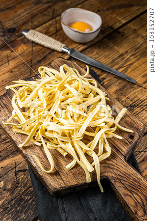 Cooking raw spaetzle egg noodle. Wooden background. Top view Cooking raw spaetzle egg noodle. Wooden background. Top view 103152707