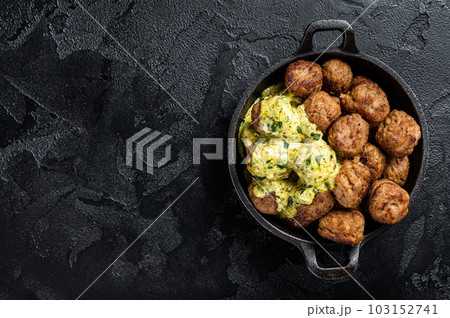 Skillet with Swedish beef Meatballs with Cream Sauce. Black background. Top view. Copy space Skillet with Swedish beef Meatballs with Cream Sauce. Black background. Top view. Copy space 103152741