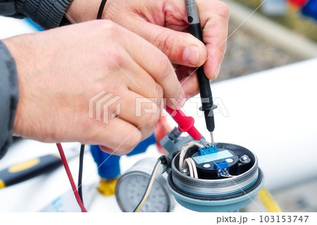 Checking gas equipment sensor with multimeter. Close-up hands. Diagnostics of industrial equipment. 103153747