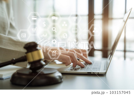 Justice and law concept.Female judge in a courtroom the gavel, working with digital tablet computer on wood table in sun light. Justice and law concept.Female judge in a courtroom the gavel, working with digital tablet computer on wood table in sun light. 103157045