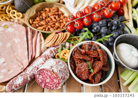Fresh bread, pastries. Table full of mediterranean appetizers, tapas or antipasto. Assorted Italian food set. Delicious snack on party or picnic time. Italian style banquet. Fresh bread, pastries. Table full of mediterranean appetizers, tapas or antipasto. Assorted Italian food set. Delicious snack on party or picnic time. Italian style banquet. 103157245