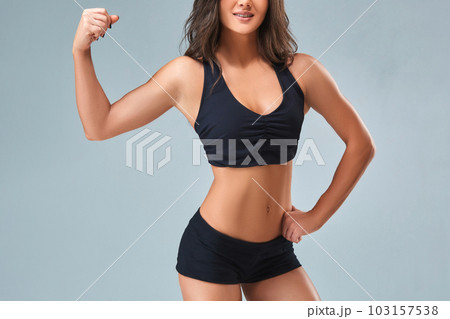 Slim woman's body over grey background 103157538