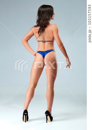 Sexy brunette bodybuilder woman in blue bikini. Sexy brunette bodybuilder woman in blue bikini. 103157593