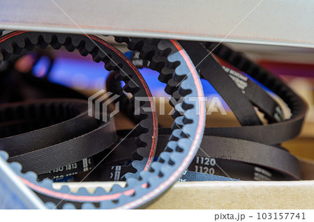 Toothed drive belt for a compressor in a box in stock. Close-up. Toothed drive belt for a compressor in a box in stock. Close-up. 103157741