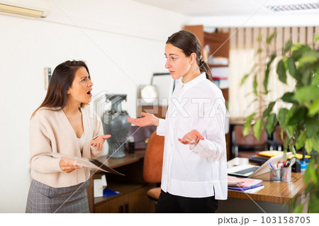 Unhappy woman chief screaming to young female manager Unhappy woman chief screaming to young female manager 103158705