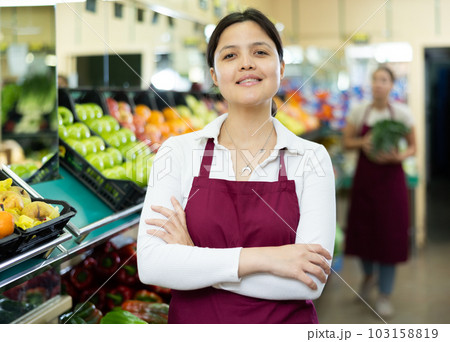 Asian woman seller stands with arms crossed on chest and waits for customers Asian woman seller stands with arms crossed on chest and waits for customers 103158819