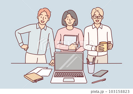 Business team smiling standing near desk with laptop in office and reporting to manager on work done Business team smiling standing near desk with laptop in office and reporting to manager on work done 103158823